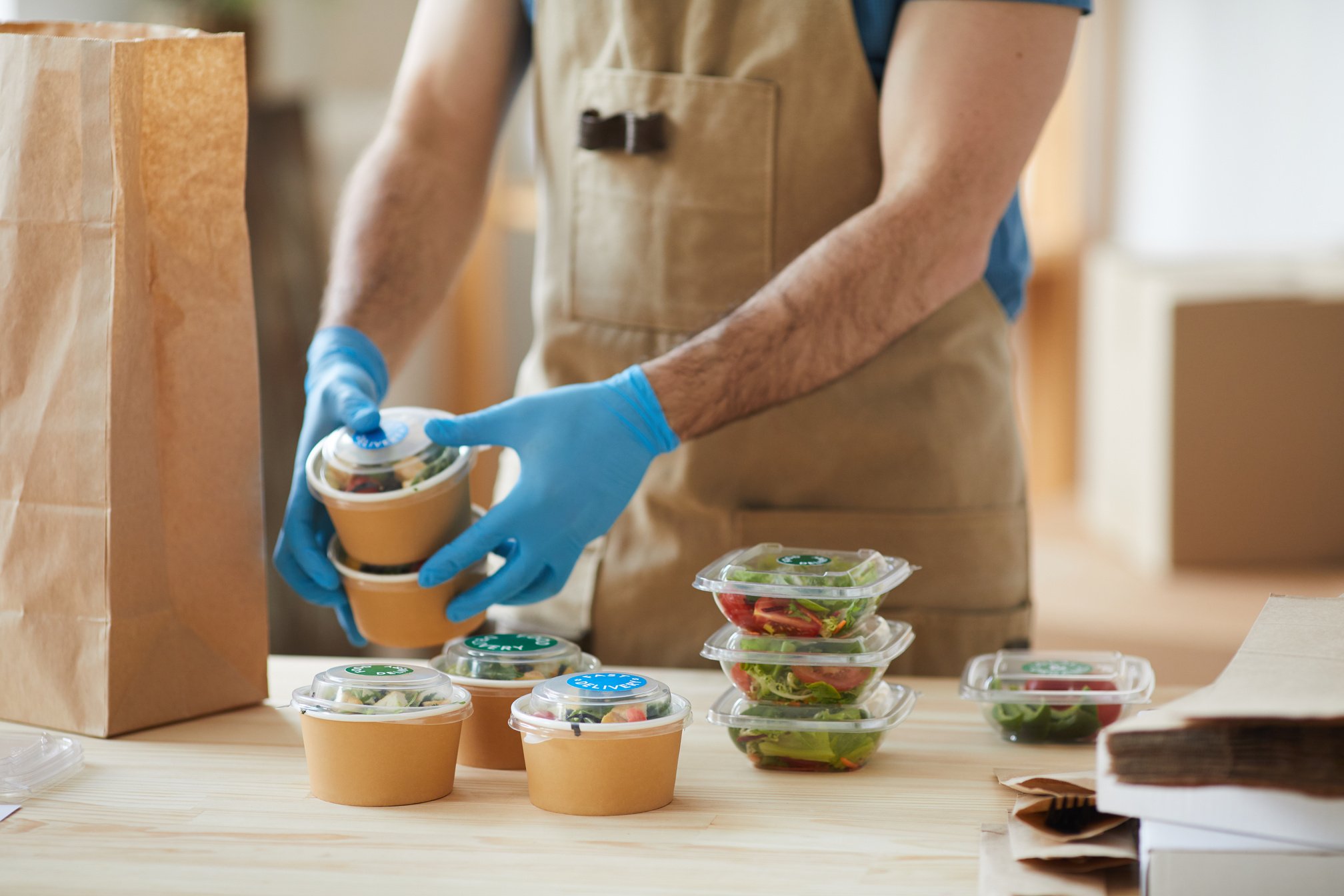 Worker Wearing Gloves at Food Delivery Service