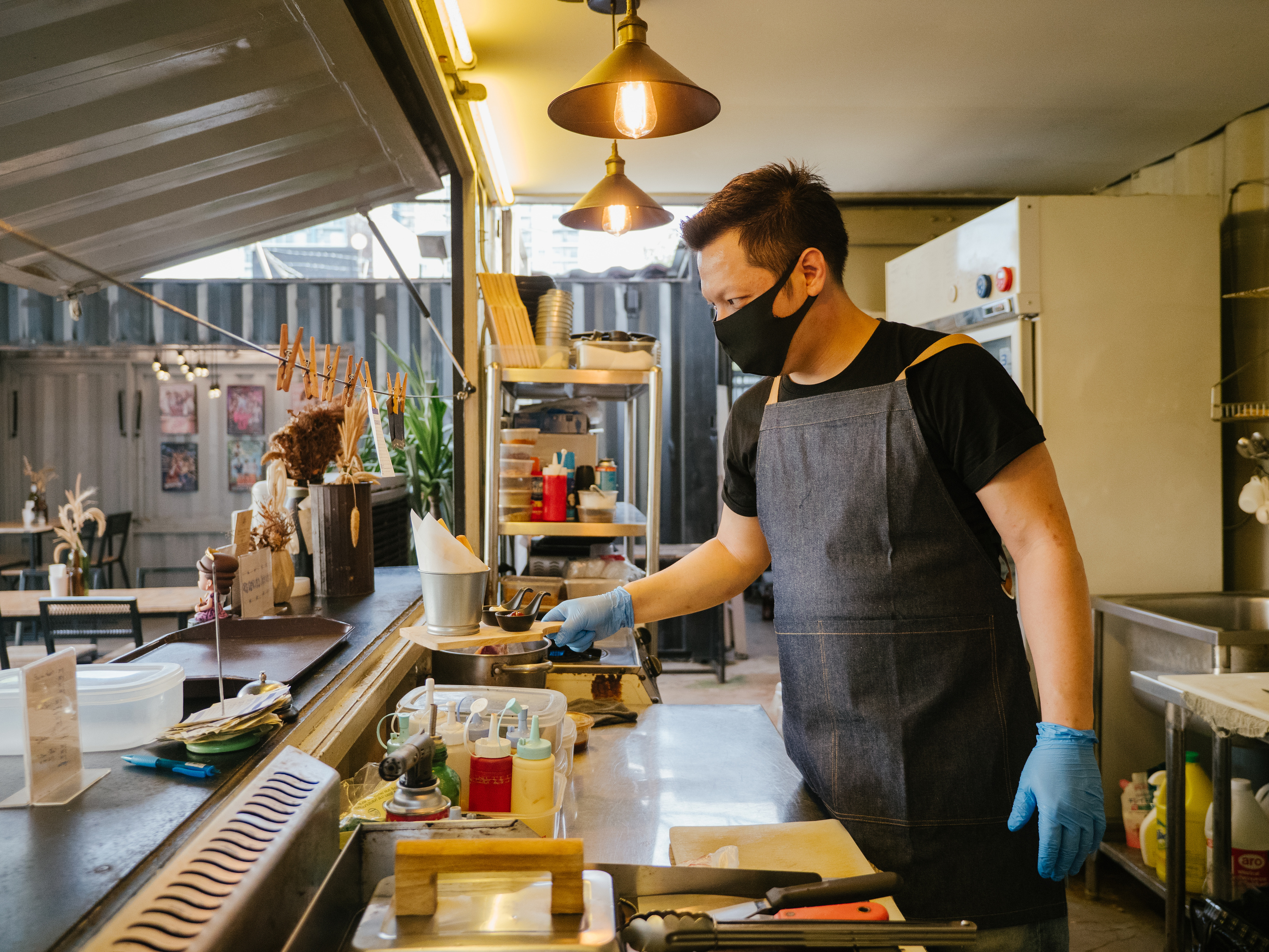 Asian owner with food truck, small business.